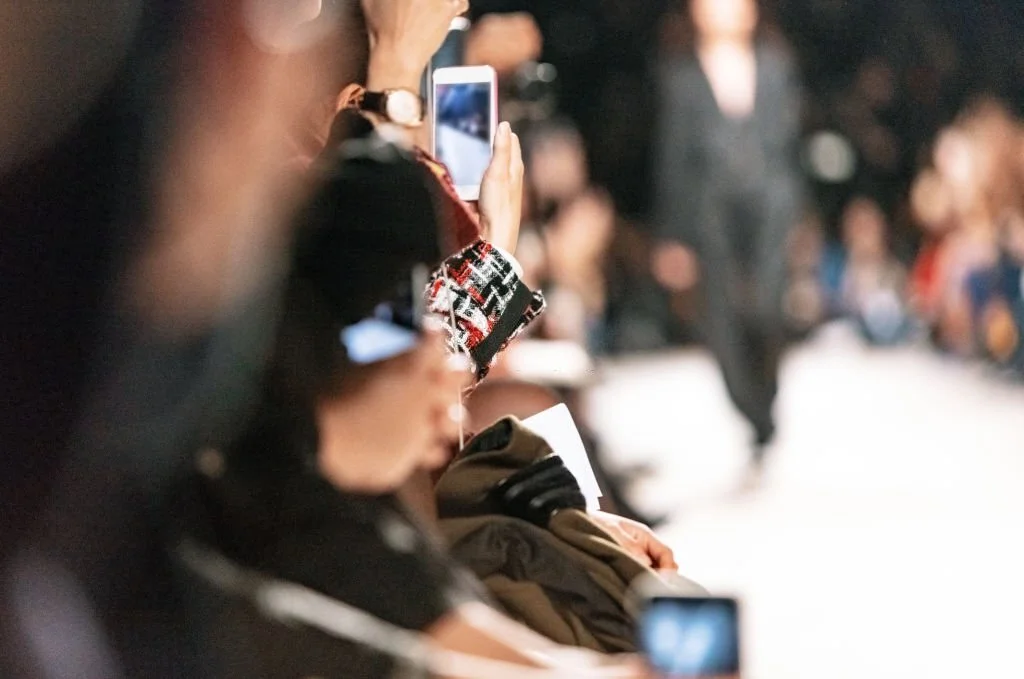 People using smart phone to film fashion show