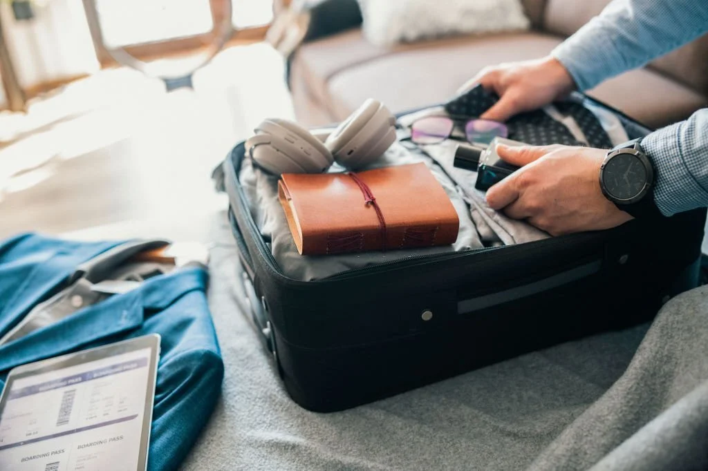 Unrecognisable man packing his suitcase for a business trip