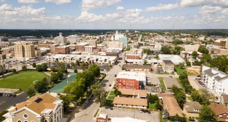 The downtown city skyline and buildings of Springfield MO under partly cloudy skies aerial perspective