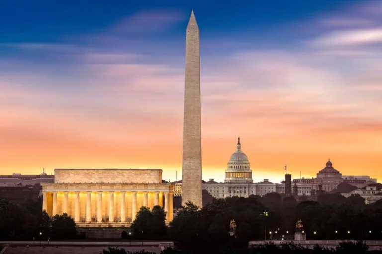 New Dawn over Washington DC Skyline- 3 iconic monuments illuminated at sunrise: Lincoln Memorial, Washington Monument and the Capitol Building.