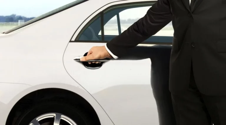 A chauffeur in black suit opening white car door from chauffeur service in la