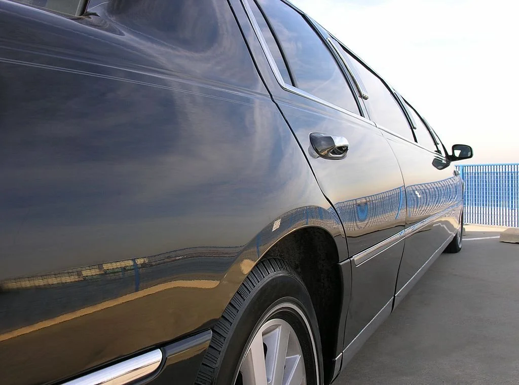 View of a Black Strech Limousine from the back.