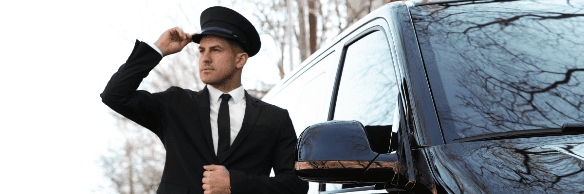 Private chauffeur is standing by the car
