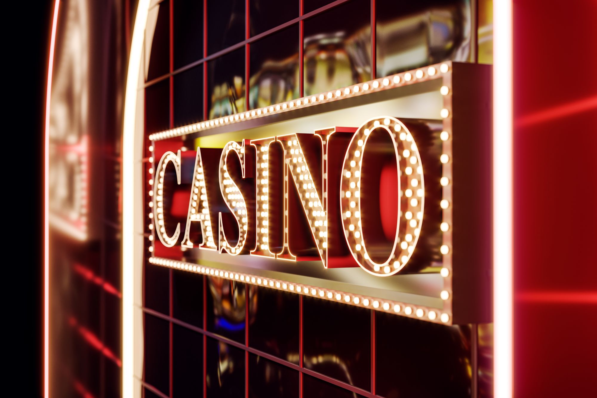 Illuminated casino sign above a casino entrance at night